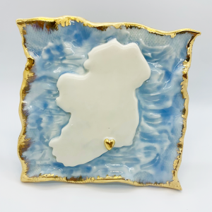 Give the gift of home with this delicately handmade heirloom porcelain piece. Uisce na hEireann is a high fired porcelain map of Ireland with a heart (or hearts) placed in any location of your choice set on cornflour blue seas with a 9ct gold edging. 